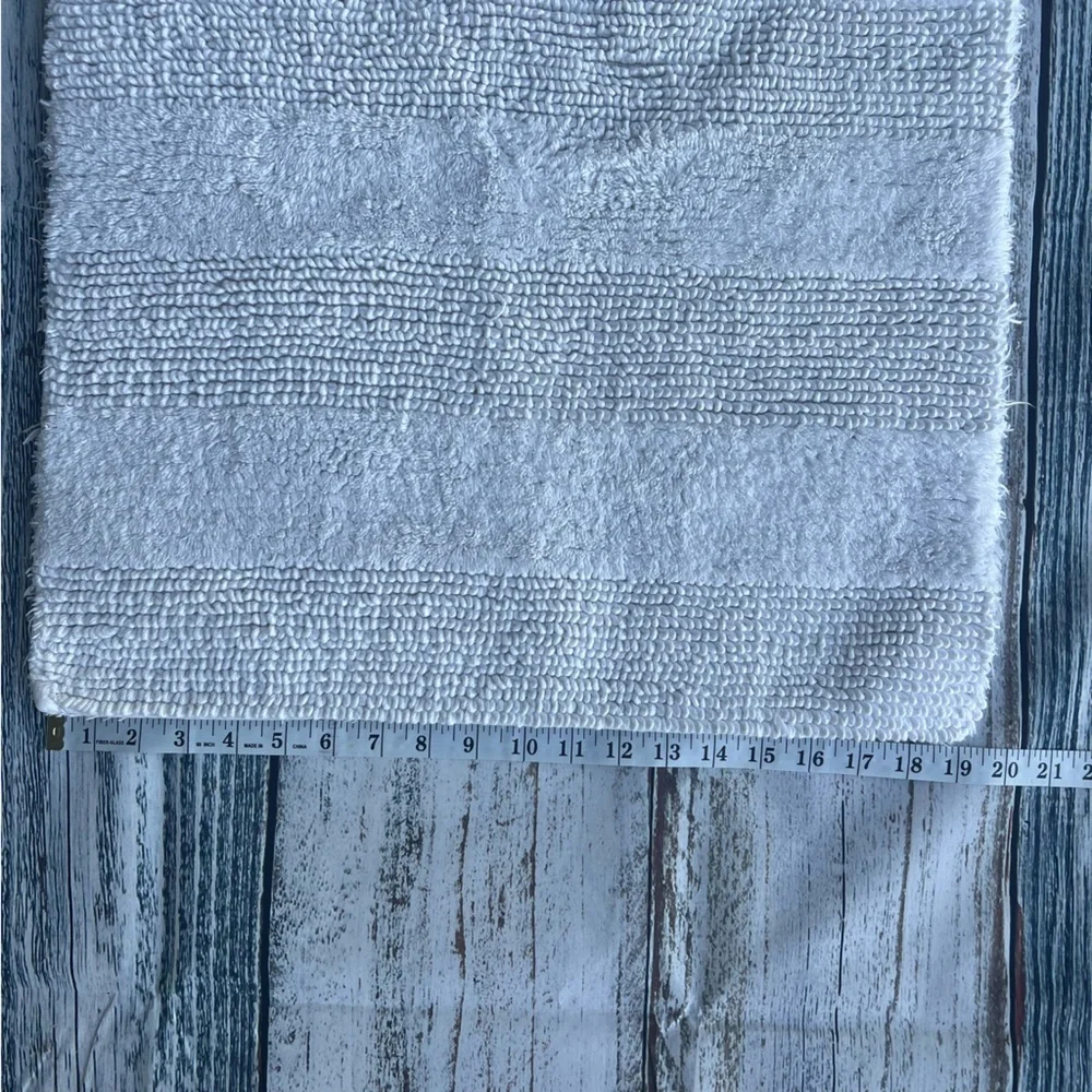 DKNY white bathroom rug 33in x 19in EUC